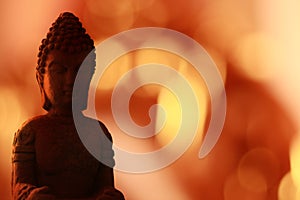 Buddha Statue close-up with bokeh lights background