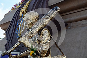 Buddha statue with enormous gold leafs.