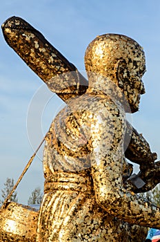 Buddha statue with enormous gold leafs.