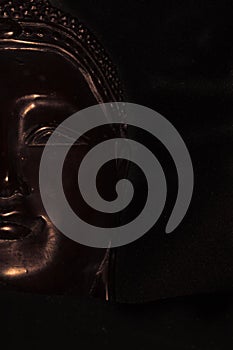 Buddha statue half face lines highlighted on black background