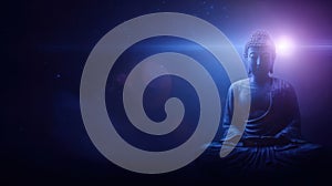 Buddha statue illuminated by subtle light in a dark setting