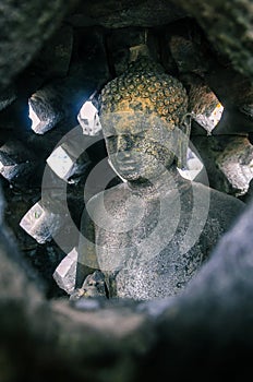 Buddha Statue inside one of the stupa structure of Borobudur Temple, Magelang, Central Java, Indonesia, 25 December 2019