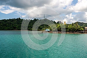 Buddha Statue on the island with pier and hut