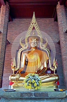 The Buddha statue is located indoors.