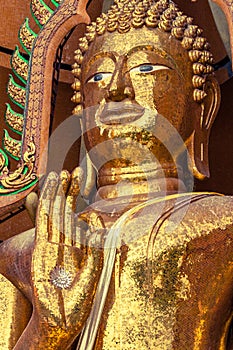 Buddha statue made from square yellow glass.