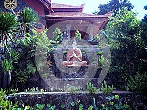 Buddha Statue In The Middle Of The Buddhist Temple Garden At Brahmavihara Arama Monastery