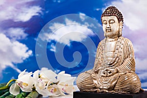 Buddha statue with orchid flower