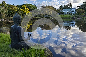 Buddha statue over looking a lake