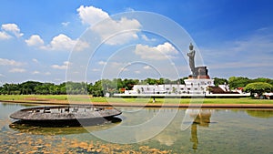 Buddha statue with reflection on pond
