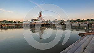 Buddha statue and reflection on water at Buddhamonthon, in Phra