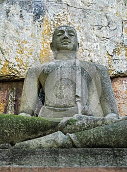 Buddha statue sitting in the lotus position, made of concrete
