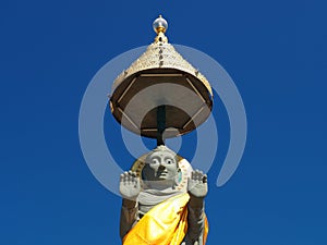 Buddha statue soars into blue sky