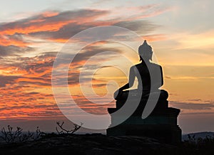 Buddha statue on sunset sky background