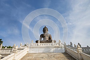 Buddha statue in temple with blue sky background
