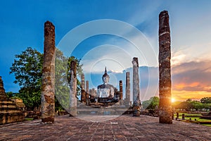 Buddha statue and Wat Mahathat Temple in the precinct of Sukhothai Historical Park