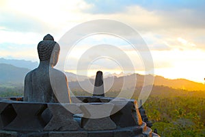 Buddha Statue Watching the Sunset Over Borobodur Temple