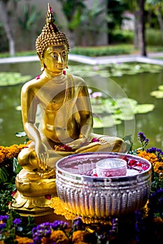 Buddha statue with water bowl