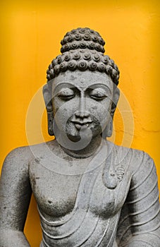 Buddha Statue  On Yellow French Colony Wall Background, Granite Buddha Statue Portrait