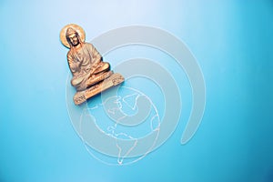 Buddha statuette on the earth