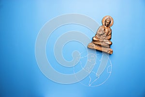 Buddha statuette on the earth