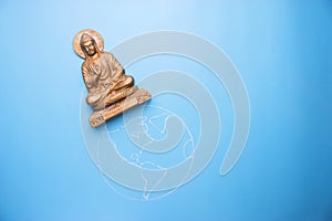 Buddha statuette on the earth