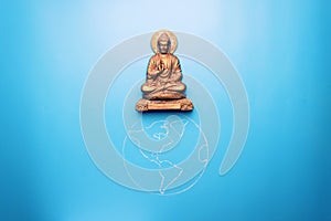 Buddha statuette on the earth