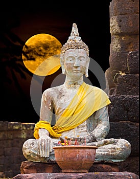 Buddha status of subduing Mara sitting under the moonlight.
