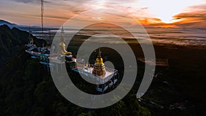 Buddha on the top Mountain of Wat Tham Seua Tiger Cae , Krabi,Thailand photo