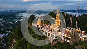 Buddha on the top Mountain of Wat Tham Seua Tiger Cae , Krabi,Thailand photo