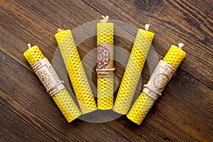 Buddhism. Candles with Yantras and mantras in sanskrit on dark wooden background top view