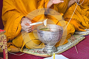 Buddhism monks are pray and formalize the holy water or the blessed water