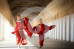 Buddhism novices are walking with umberella in temple