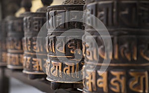 Buddhism obsolete prayer wheels in row