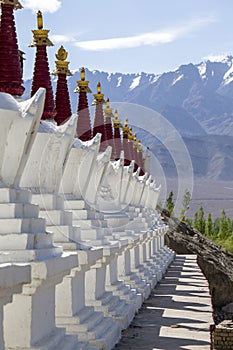 Buddhist chortens, white stupa and Himalayas mountains in the background near Shey Palace in Ladakh, India