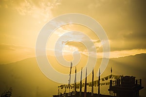 Buddhist flags at sunset panoramic view, from a sikkim hill station viewpoint. Beautiful summertime, peaceful scenic view at dusk