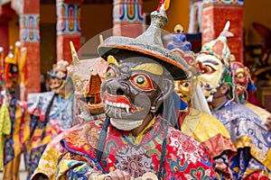 Buddhist lamas dressed in mystical mask dancing Tsam mystery dance in time of Yuru Kabgyat Buddhist festival at Lamayuru Gompa, La