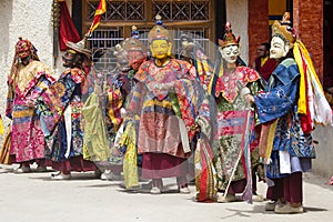 Buddhist lamas dressed in mystical mask dancing Tsam mystery dance in time of Yuru Kabgyat Buddhist festival at Lamayuru Gompa, La