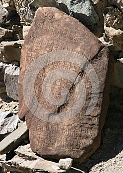 Buddhist mantra on red stone