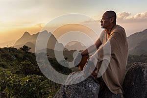 Buddhist master monk meditating in mountains