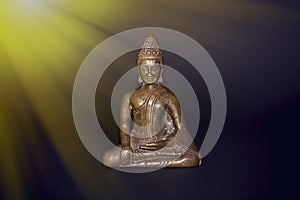 Buddhist meditation. Traditional bronze buddha meditating in ray