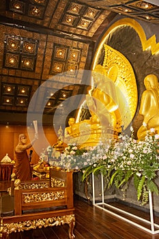 Buddhist monk blessing buddha statue