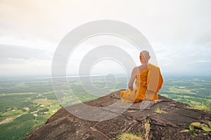 Buddhist monk in meditation at beautiful nature