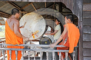 Buddhist Monk playing big drum at Champasak on Laos