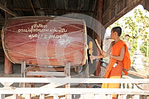 Buddhist Monk playing big drum at Champasak on Laos