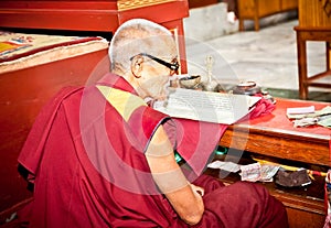 Buddhist monk is reading mantra in Bouddanath in Kathmandu