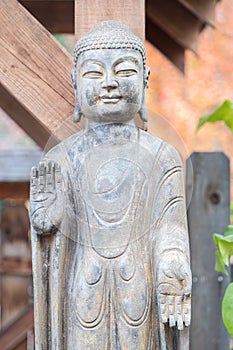 Buddhist monk statue with hands facing outward