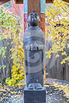 Buddhist Monk statue holding alms bowl looking up