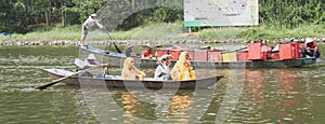 Buddhist monks in boat, Perfume Pagoda, Hanoo, Vietnam photo