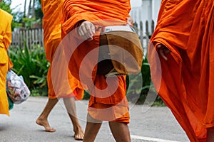 Buddhist monks collect alms in Luang Prabang, Laos