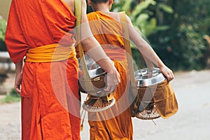 Buddhist monks during Laotian traditional sacred alms giving ceremony in Luang Prabang city, Laos photo